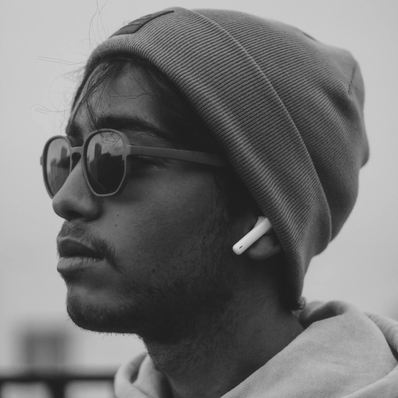 Monochrome portrait of a young man wearing a beanie and sunglasses in Marrakech.